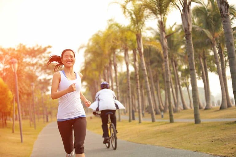 A fit Asian woman jogging in a park