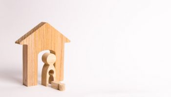 A wooden figure of a woman and a fallen child from the emptiness of her body