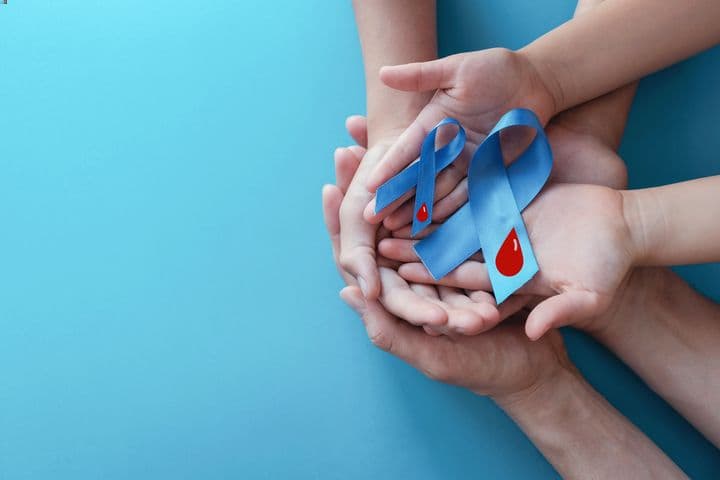 Light blue ribbons with blood on a blue background to symbolise World Diabetes Day