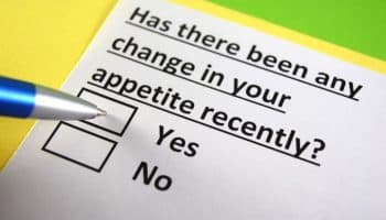 A blue pen tip on a ‘Yes’ or ‘No’ questionnaire