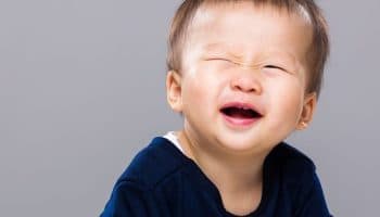  Boy blinking his eyes while smiling