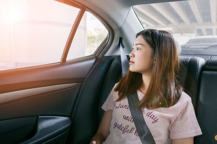 Girl in car looking outside window