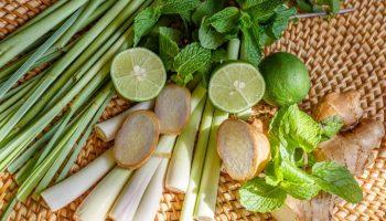 Fresh lemongrass, ginger, mint, and lime in a basket