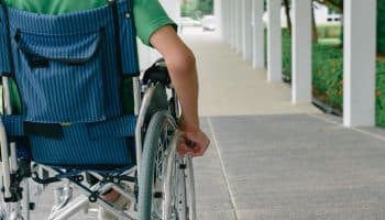 Person on a wheelchair wheeling by himself