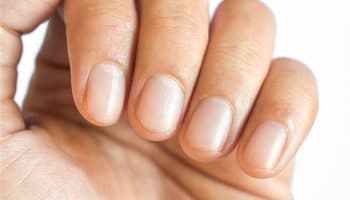 Close-up of nails of a person’s index, middle, ring, and baby fingers.