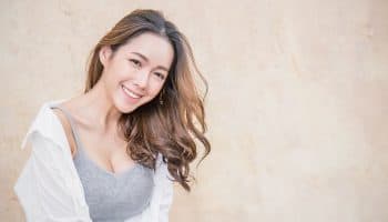 A young Asian woman smiling at the camera.