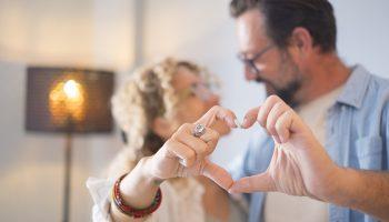 A couple forming the shape of a heart with