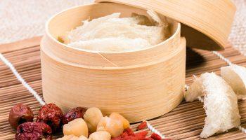 A selection of edible bird nest inside a wooden tray with other TCM ingredients