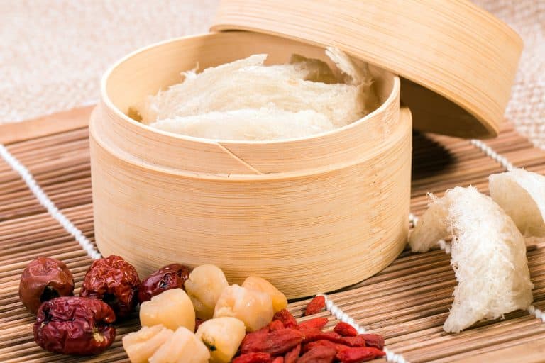 A selection of edible bird nest inside a wooden tray with other TCM ingredients