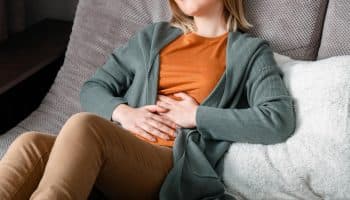 A woman touching her stomach due to period pain