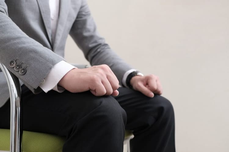 Image of a nervous man's clenched fists during a job interview