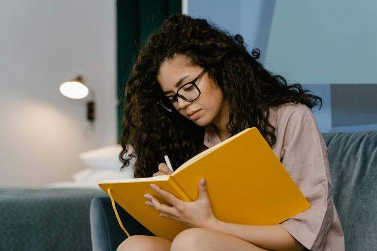 A woman writing in her journal.